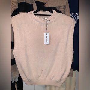 Beige sleeveless knit top with shoulder pads